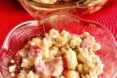 a bowl filled with food sitting on top of a red tablecloth next to another bowl full of food