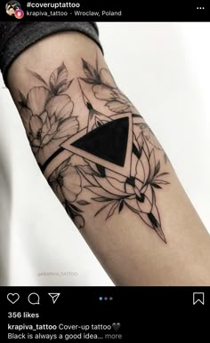 a black and white tattoo with flowers on the arm