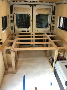 the inside of a van with wood framing