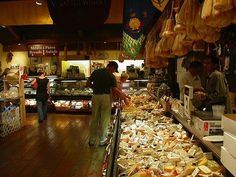 people shopping in a store with lots of food