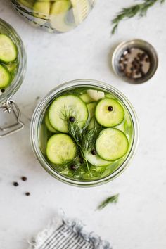 pickled cucumbers in jars with herbs and spices