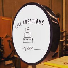 a sign that says cake creations by kate in front of some other signs and tools