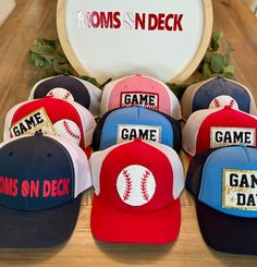 Step up to the plate in style with our Baseball Mom hats! Designed for the ultimate team supporter, these hats & visors offer both comfort and flair, featuring trendy designs and durable materials. Whether you're shading yourself from the sun during games or running errands around town, our baseball mom hats are the perfect accessory to show off your team pride. Choose from either the 'Merica, the Moms On Deck logo, Game Day in a chenille patch or a baseball in a chenille.  The hats can personalized with a chenille player's number.  The visors come with either the Moms on Deck logo or MOM in a baseball chenille patch.  Grab yours today and hit a style home run! Baseball Cap For Tailgating During Baseball Season, Baseball Season Trucker Hat With Letter Print, Red Sports Fan Hat For Baseball Season, Red Snapback Hat For Baseball Season Game Day, One Size Trucker Hat With Visor For Sports Events, Red Snapback Hat For Baseball Game Day, Red Hats For Baseball Season, Game Day Trucker Hat With Curved Brim, Patriotic Sports Hats One Size Fits Most