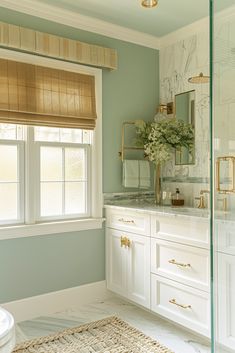 a bathroom with marble counter tops and white cabinets, along with a large window in the corner