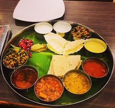 a metal plate topped with lots of different types of food