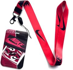 a red lanyard with a black nike logo on it