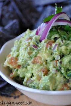 a white bowl filled with guacamole and onions