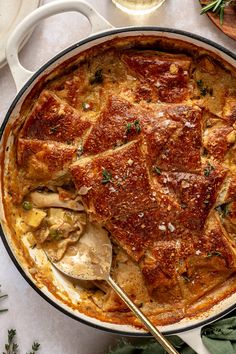 a casserole dish with meat and vegetables in it