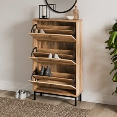 a wooden shoe rack with several pairs of shoes