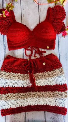 two pieces of red and white crocheted bikinisuits with flowers on the side