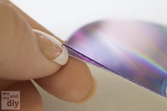 a close up of a person holding a compact disc