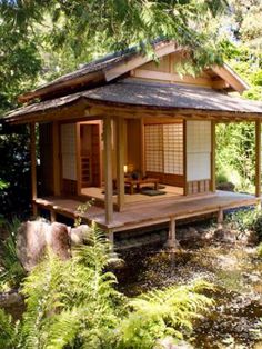 a small japanese style house in the woods