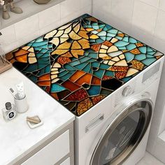 a washer and dryer sitting next to each other in a room with tile on the floor