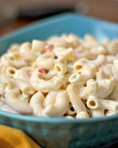 a blue bowl filled with macaroni and cheese