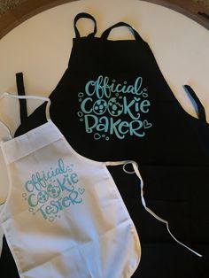 two aprons that say official cookie maker and one with the word cookies on it