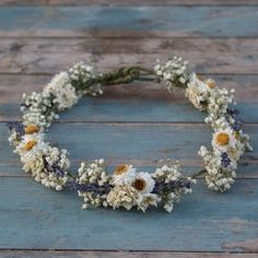 a wreath made out of flowers sitting on top of a wooden floor