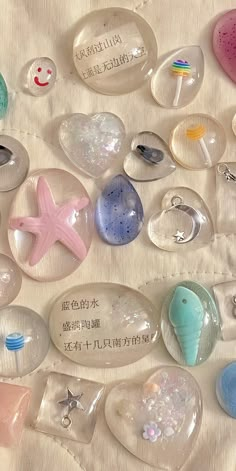 there are many different sea glass items on the table together, including starfishs and seashells