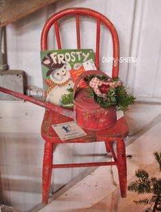 an old red chair with a christmas decoration on it and a sign that says frosty