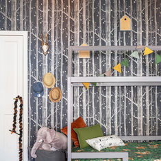 a child's room with trees and birds on the wall