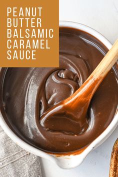 peanut butter balsamic caramel sauce in a white bowl with a wooden spoon