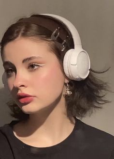 a woman with headphones on her ears