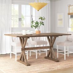 a dining room table with two chairs and a bench