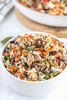 a white bowl filled with rice and vegetables