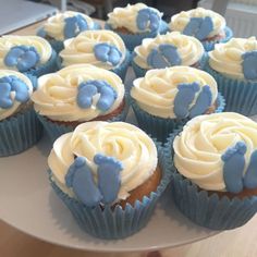 blue and white cupcakes with frosting in the shape of elephants on top