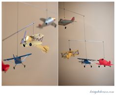 two pictures of airplanes hanging from the ceiling and one has an airplane mobile attached to it