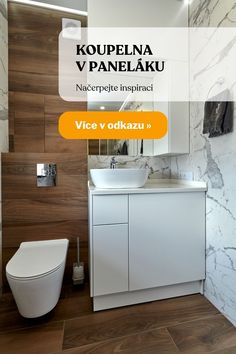 a bathroom with a toilet, sink and mirror on the wall next to a wooden floor