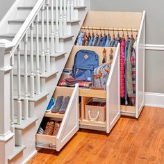 an under the stairs storage area with shoes and bags