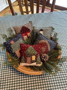 a wooden bowl filled with pillows on top of a table