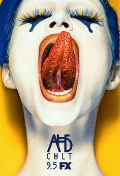 a woman with blue hair and makeup has her tongue open to show the inside of her mouth