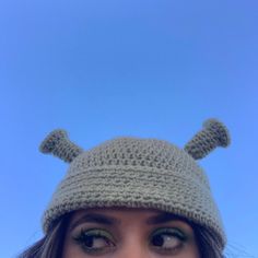 a woman wearing a crocheted hat with ears