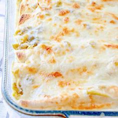 a casserole dish with cheese and vegetables in it