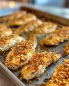 some chicken is sitting on a baking sheet