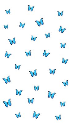 a group of blue butterflies flying in the sky