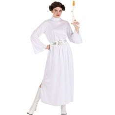 a woman dressed in a white costume holding an orange stick and pointing to the side