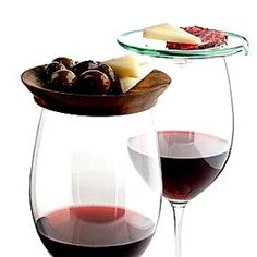 two wine glasses filled with red wine and cheese