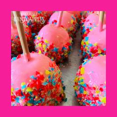 pink cake pops with sprinkles and strawberries on top are ready to be eaten