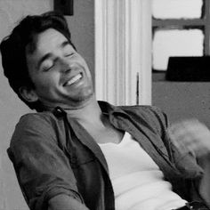 a black and white photo of a man laughing