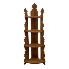 three tiered wooden shelf with carvings on the top and bottom, against a white background