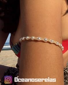 a woman wearing a bracelet on the beach