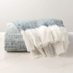 a blue and white blanket sitting on top of a table