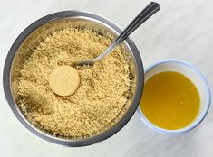 a bowl filled with oatmeal next to a cup of honey and spoon