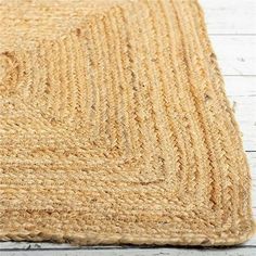 an area rug on the floor with white wooden floors and wood planks in the background