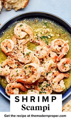 shrimp scampi in a bowl with bread on the side and text overlay that reads shrimp scampi get the recipe at the modern proper