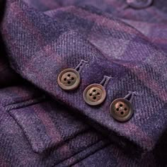 two buttons on the lapel of a purple jacket