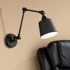 a black wall light next to a chair