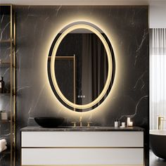 a bathroom with a round mirror and black marble counter top next to a bathtub